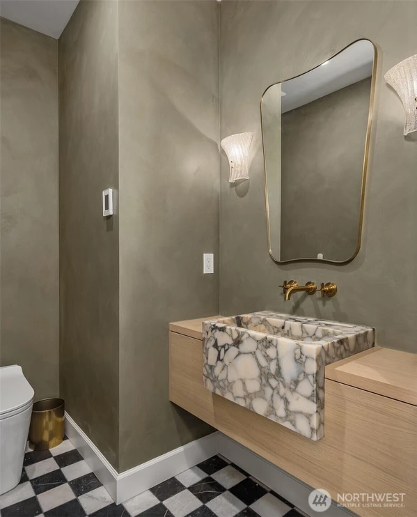 Powder bath.  Single block carved sink, marble flooring.