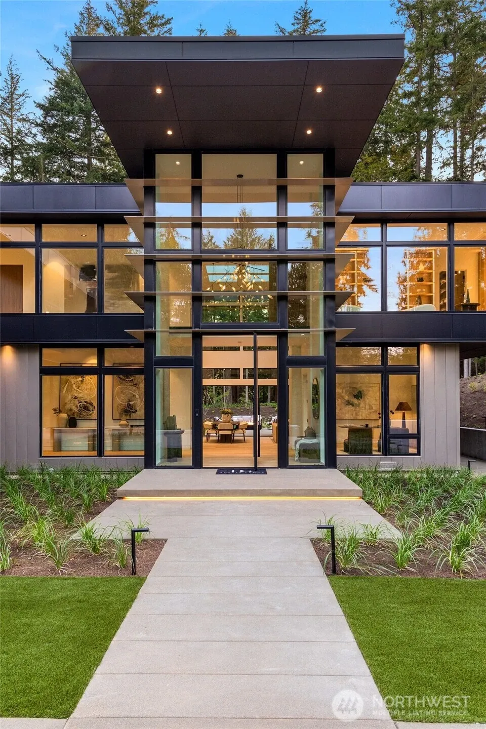 Custom fins frame the grand entry with an oversized pivot door.